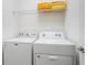 Bright laundry area featuring a Maytag washer and dryer with a storage shelf, perfect for convenience at 2613 Calistoga Ave, Kissimmee, FL 34741