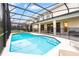 Beautiful enclosed pool area, showcasing a sparkling pool with steps, lounge chairs, and an entertainment area at 2613 Calistoga Ave, Kissimmee, FL 34741