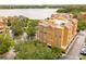 Aerial view of condo building, showcasing the building's architecture near a scenic lake at 7500 Toscana Blvd # 331, Orlando, FL 32819