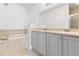 Bathroom features a double vanity, soaking tub, and tiled surround, offering a luxurious retreat at 7500 Toscana Blvd # 331, Orlando, FL 32819