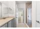 Bright bathroom with a vanity, shower and open doorway to a bright bedroom and hallway at 7500 Toscana Blvd # 331, Orlando, FL 32819