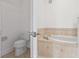 Cozy bathroom featuring a toilet and an elegant tiled soaking tub for relaxation at 7500 Toscana Blvd # 331, Orlando, FL 32819