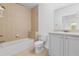 Cozy bathroom featuring a tub, toilet, and modern vanity with sink at 7500 Toscana Blvd # 331, Orlando, FL 32819