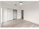 Bright bedroom with wood-look floors and a closet with shelving at 7500 Toscana Blvd # 331, Orlando, FL 32819