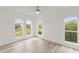 Bedroom featuring wood-look flooring and three windows letting in natural light at 7500 Toscana Blvd # 331, Orlando, FL 32819