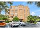 A well-maintained condo building featuring balconies, landscaping, and parking spots for residents at 7500 Toscana Blvd # 331, Orlando, FL 32819