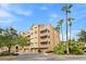 A lovely condo building with outdoor balconies, exterior garages, and surrounding tropical landscaping at 7500 Toscana Blvd # 331, Orlando, FL 32819