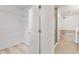 Walk-in closet with shelving and door to bright bathroom with soaking tub and shower at 7500 Toscana Blvd # 331, Orlando, FL 32819
