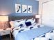 Stylish bedroom with a blue accent wall, comfortable bed, and closet for ample storage at 7858 Spectrum Dr, Reunion, FL 34747