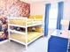 Bright and playful bedroom with bunk beds, Minion-themed decor, and plenty of natural light at 7858 Spectrum Dr, Reunion, FL 34747