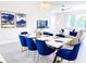 Elegant dining area with a table set for six, with modern lighting and decor at 7858 Spectrum Dr, Reunion, FL 34747