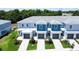 Beautifully landscaped townhomes with attached garages, offering modern living and curb appeal at 7858 Spectrum Dr, Reunion, FL 34747