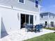 Outdoor patio with a dining set, ideal for enjoying meals or relaxing in the backyard at 7858 Spectrum Dr, Reunion, FL 34747