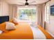 Bedroom featuring a bay window and orange bedding at 904 15Th Ne St, Winter Haven, FL 33881