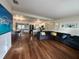 Spacious living room with open layout to kitchen, dining, and entertainment areas with hardwood flooring at 904 15Th Ne St, Winter Haven, FL 33881