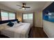 Comfortable main bedroom featuring wood floors, natural light, and a modern ceiling fan at 904 15Th Ne St, Winter Haven, FL 33881