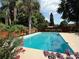 Inviting pool surrounded by lush landscaping, creating a private oasis for relaxation at 904 15Th Ne St, Winter Haven, FL 33881
