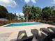 A sparkling pool with lounge chairs for enjoying sunny days in a serene outdoor setting at 904 15Th Ne St, Winter Haven, FL 33881