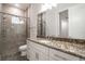 Bright bathroom with granite counters, tiled glass shower, neutral walls, and under cabinet storage at 18813 Mosby St, Orlando, FL 32833