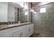 Bathroom features dual sinks with granite counters and a tiled glass shower with a small window at 18813 Mosby St, Orlando, FL 32833