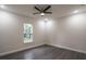 Bedroom with dark wood floors, a ceiling fan, recessed lights, base trim and a window with natural light at 18813 Mosby St, Orlando, FL 32833