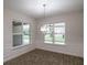 Bright dining room featuring wood-look tile floors and a modern chandelier at 18813 Mosby St, Orlando, FL 32833