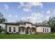 Beautiful home with stone accents, a covered front porch, and a well-manicured lawn at 18813 Mosby St, Orlando, FL 32833