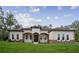 Charming single-story home featuring a welcoming front porch, stone accents, and a well-manicured lawn at 18813 Mosby St, Orlando, FL 32833