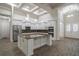 Bright, open-concept kitchen featuring a large island, stainless steel appliances, and modern finishes at 18813 Mosby St, Orlando, FL 32833