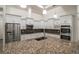 Spacious kitchen featuring a large island with granite countertops, custom cabinets, and stainless appliances at 18813 Mosby St, Orlando, FL 32833