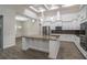 Open kitchen with custom cabinets, stainless appliances, a center island, and granite countertops at 18813 Mosby St, Orlando, FL 32833