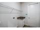 Functional laundry room with a sink and storage shelving at 18813 Mosby St, Orlando, FL 32833
