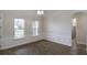 Bright room with wood floors, decorative trim, natural light, and an archway leading to another room at 18813 Mosby St, Orlando, FL 32833