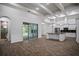 Open-concept with wood floors, coffered ceilings, and a kitchen island at 18813 Mosby St, Orlando, FL 32833