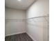 Walk-in closet with metal racking system and wood-look floors at 18813 Mosby St, Orlando, FL 32833