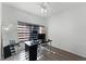 This home office has a ceiling fan, window with shade, and a work space at 3643 Weatherfield Dr, Kissimmee, FL 34746