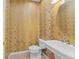 Elegant powder room with decorative wallpaper, a pedestal sink, and a round mirror at 1011 Wood Cv, Kissimmee, FL 34743