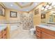 Elegant bathroom featuring a soaking tub, glass-enclosed shower, and granite countertops at 1011 Wood Cv, Kissimmee, FL 34743