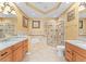 Luxurious bathroom with dual sinks, a separate shower, a soaking tub, and elegant tile work at 1011 Wood Cv, Kissimmee, FL 34743