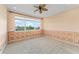 Well-lit bedroom with decorative wall panels and a carpeted floor, providing a peaceful atmosphere at 1011 Wood Cv, Kissimmee, FL 34743