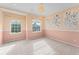 Stylish bedroom featuring a two-tone wall design, carpeted floors, and bright natural lighting at 1011 Wood Cv, Kissimmee, FL 34743