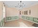 Bright entryway featuring tile flooring, a modern chandelier, and natural light streaming through multiple windows at 1011 Wood Cv, Kissimmee, FL 34743
