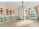 Bright entryway featuring tile flooring, a modern chandelier, and natural light streaming through multiple windows at 1011 Wood Cv, Kissimmee, FL 34743