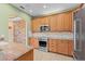 Well-equipped kitchen boasts granite countertops, stainless steel appliances, and wooden cabinetry at 1011 Wood Cv, Kissimmee, FL 34743