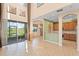 Light-filled living area with high ceilings, tile floors, and a view of the backyard lake at 1011 Wood Cv, Kissimmee, FL 34743