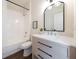 Well-lit bathroom with a sleek vanity, framed mirror, and tiled shower for a relaxing experience at 14217 Sapphire Bay Cir, Orlando, FL 32828