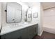 Stylish bathroom featuring a green double vanity with a marble countertop, modern fixtures, and walk-in shower at 14217 Sapphire Bay Cir, Orlando, FL 32828