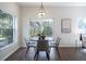 Cozy dining area with modern lighting, a round table, and a view of the backyard at 14217 Sapphire Bay Cir, Orlando, FL 32828