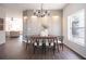 Bright dining room with a stylish chandelier, modern decor, and natural light from a large window at 14217 Sapphire Bay Cir, Orlando, FL 32828