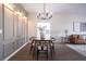 Elegant dining room with a stylish chandelier, modern decor, and flows into the living area at 14217 Sapphire Bay Cir, Orlando, FL 32828